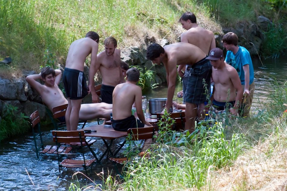 Boys in the river among nature