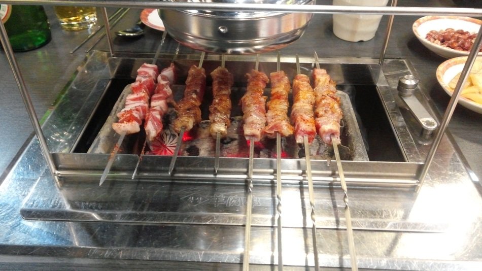cooking lamb kebabs in the restaurant