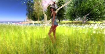 Beautiful girl on the field with the flowers near the forest