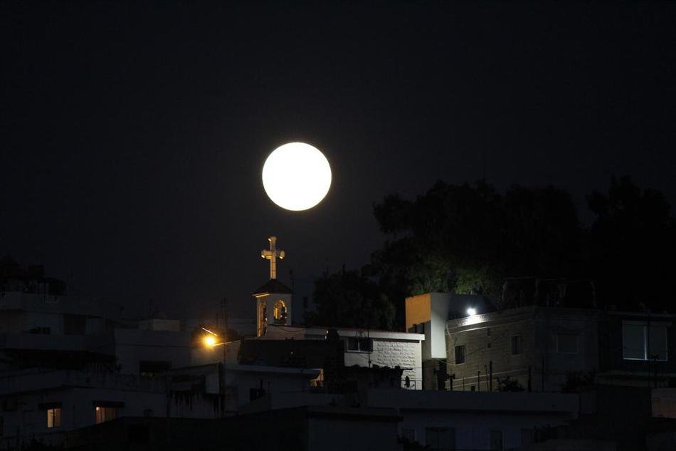 big round moon above the chapel