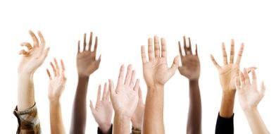 raised hands of people of different nationalities