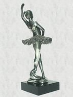 statuette of a ballerina on a gray background