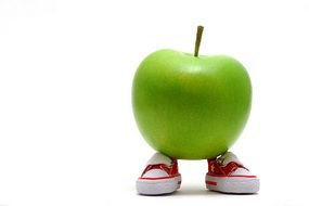 photo of a green apple on children's sneakers