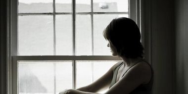 Woman looking at window