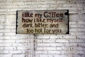 the inscription of a coffee house on a brick wall