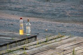 Still life with alcohol bottles near the water