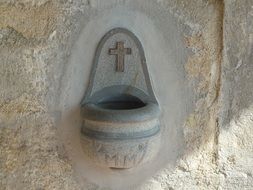 Cross on a stone drinking fountain