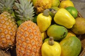 golden ripe pineapples among fruits