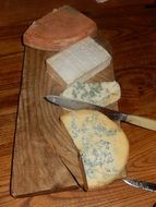 cut cheeses on board