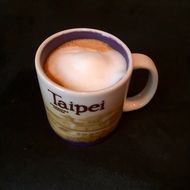 Cup with coffee on a black surface