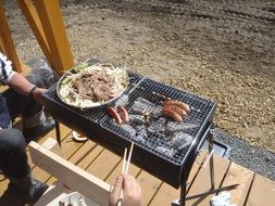 grilled sausages and barbecue on the nature