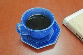 black coffee in a blue cup