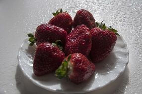 red strawberries on a white plate