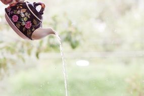 water pours from a beautiful teapot