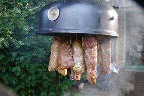 smoking meat in a garden