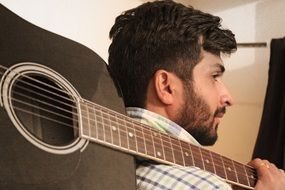 creative shooting man model with musical instrument guitar