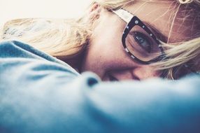 blonde girl in glasses smiling