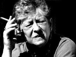 black and white picture of an old woman smoking