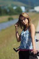 happy woman with bicycle on blurred background