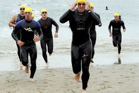 men competing in swimming and running