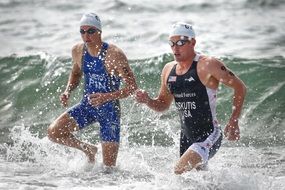athlete swimmers on a competion at the beach
