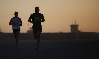 two men running at dusk