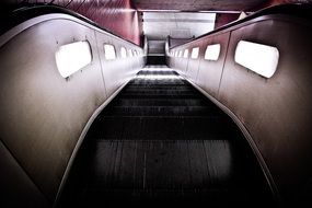 old escalator in a metro with dim lights