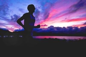 athlete jogging on an incredible sunset
