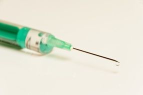 drop of medications on the syringe needle