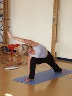 special yoga stretch on a blue mat