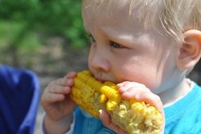 child eating sweet corn