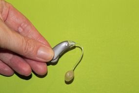 hearing aid in the hand