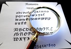 magnifying glass on calligraphic text
