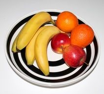 bananas, oranges and apples on the plate