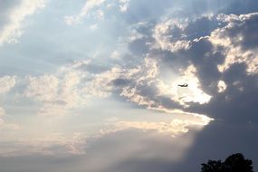 Photo of the airplane is flying on a sunny sky