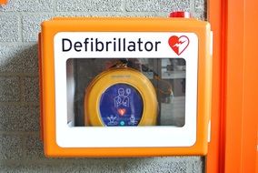 defibrillator in box on wall