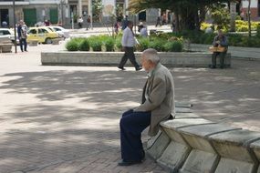 old man sitting in a park