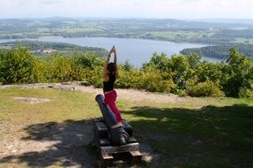 girl doing yoga on a gun on top of a hill