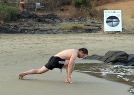 yoga exercise on the beach