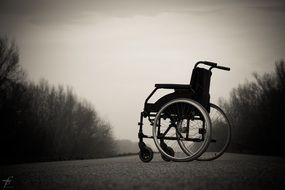 lonely wheelchair on the road