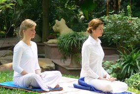 women meditate in the garden