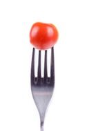 ripe tomato on a fork