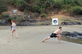 Yoga exercises on the beach