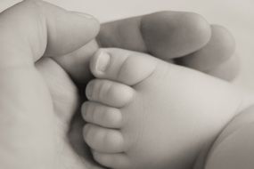 little baby foot in mom's hand