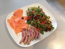 steak, salmon, salad is the main course