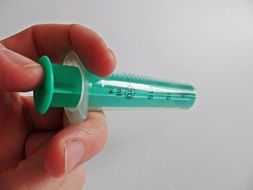 disposable syringe in hand