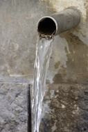 clean water pouring from a steel trumpet