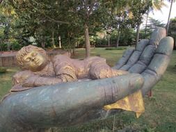 statue of a sleeping child on hand in india