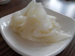 Salad with cabbage on a white plate