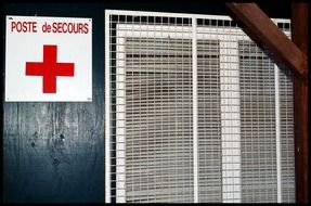 plate with a red cross on the wall